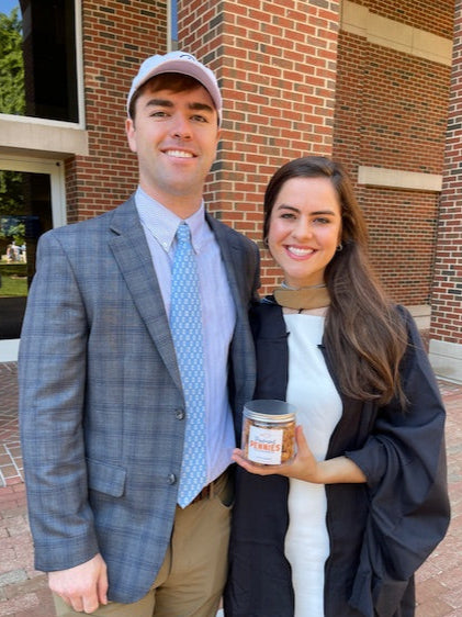 Two people standing together in front of a brick building at unc chapel hill mba